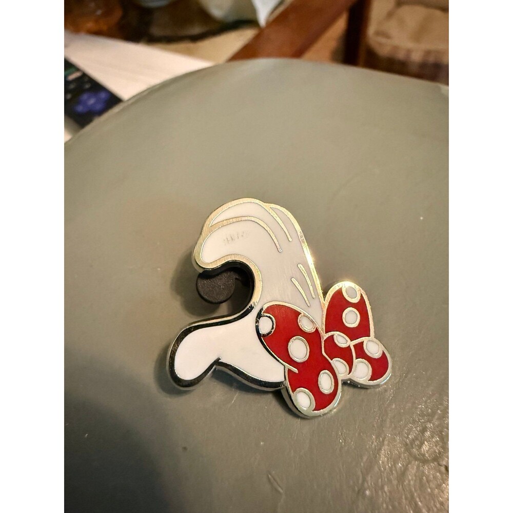 Minnie Mouse gloved hand making half of a heart
